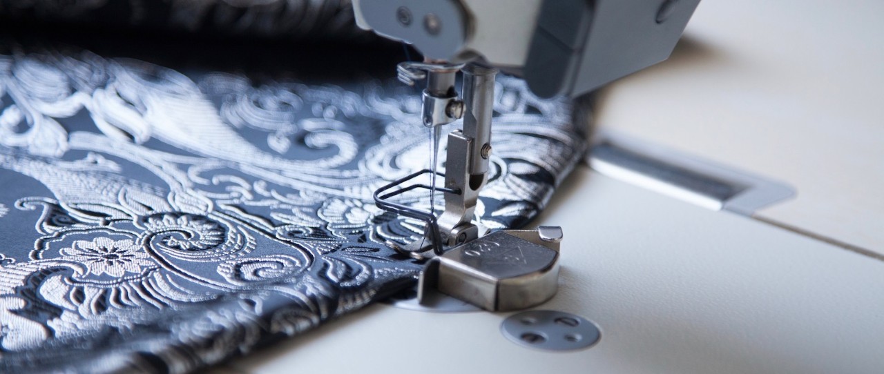 Up close sewing machine with blue patterned fabric